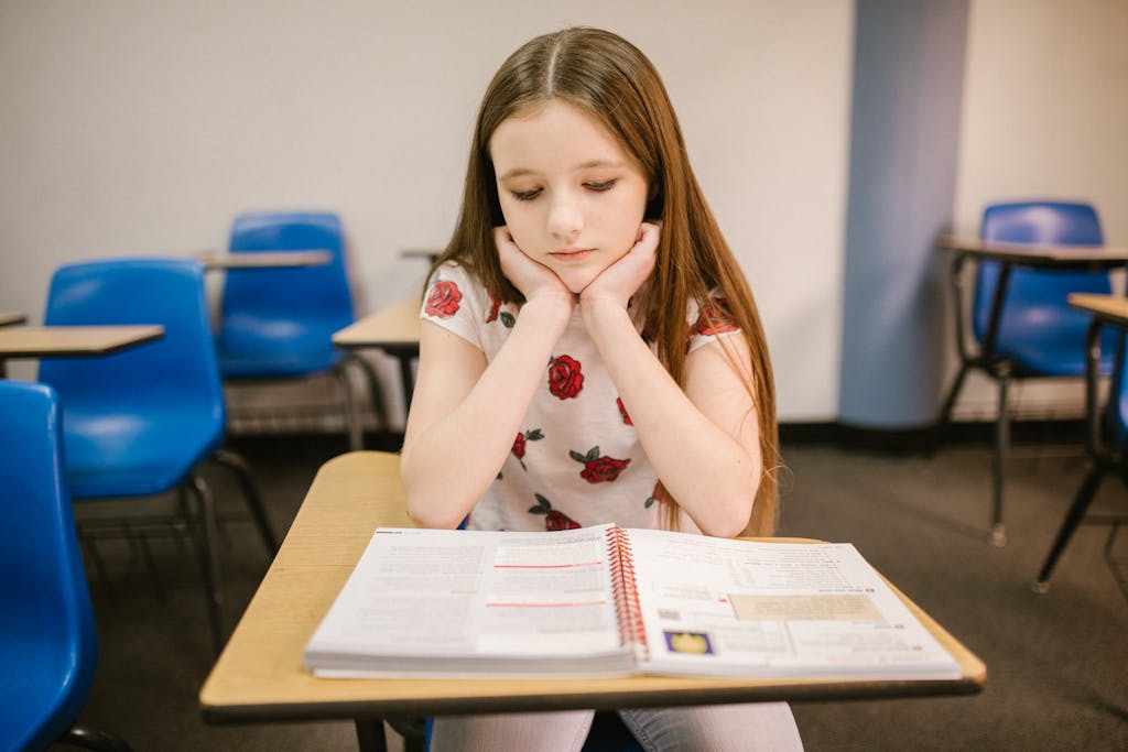 Girl Sitting on Her Desk Looking Lonely